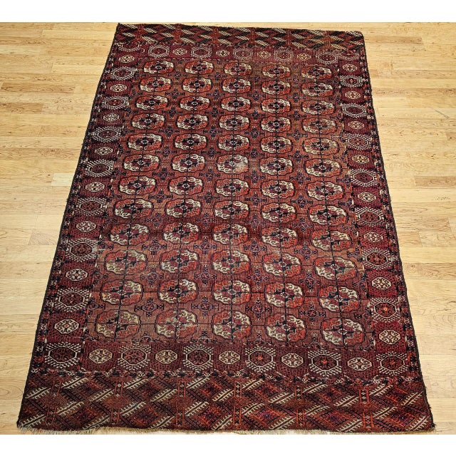 This outstanding room-size antique Turkmen Tekke rug, dating from the late 1800s, features a finely detailed allover...