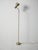 Floor lamp in gold-plated metal, elegantly curved stem, adjustable head on a gooseneck flexible hose. Clean lines with a...
