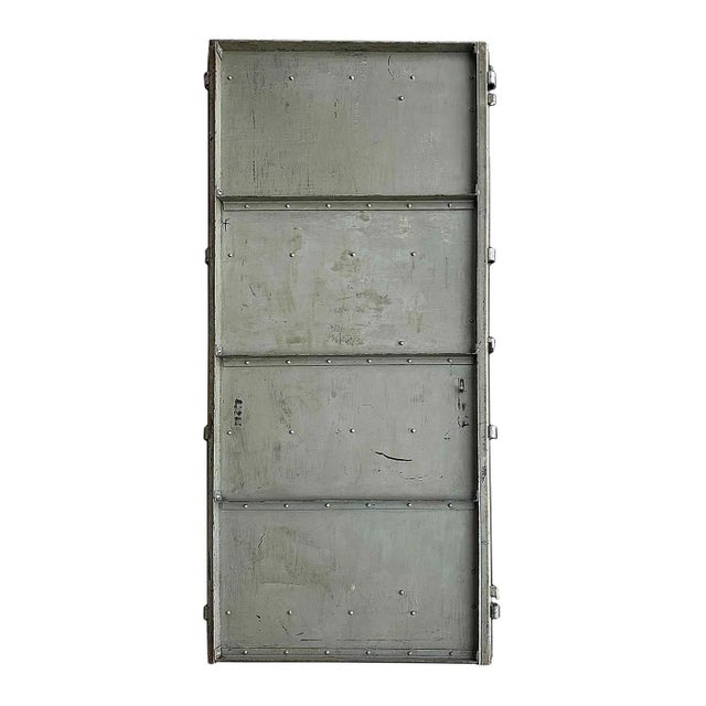 Circa 1900 antique, industrial 1/4” steel door of substantial weight, mounted on angle iron frame. Finish of distressed...