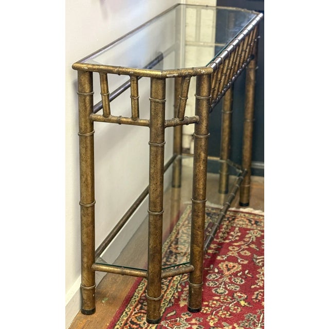 Bring a touch of Hollywood Regency glamour to your space with this chic Vintage Metal Faux Bamboo and Glass Console Sofa...
