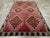 This striking mid-20th century Turkish Anatolian tribal room-size carpet, measuring 7' 2" x 12' 6", is a bold statement of...