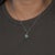 An Ethiopian opal cabochon flashes with a lively play of colour at the centre of this solid 14K white gold pendant, framed...