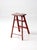 Vintage wooden step ladder featuring a weathered red painted finish, authentic paint splatter, and a beautifully aged...