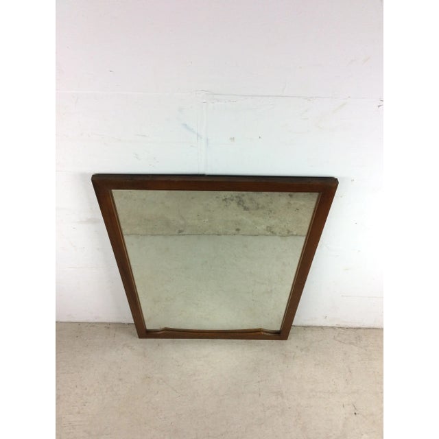 This mid century modern mirror features hardwood frame, original walnut finish, rectangular frame with two little curved...