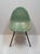 An early Mid-Century Herman Miller for Zenith style green fiberglass shell scoop chair considered to be the pre-cursor to...