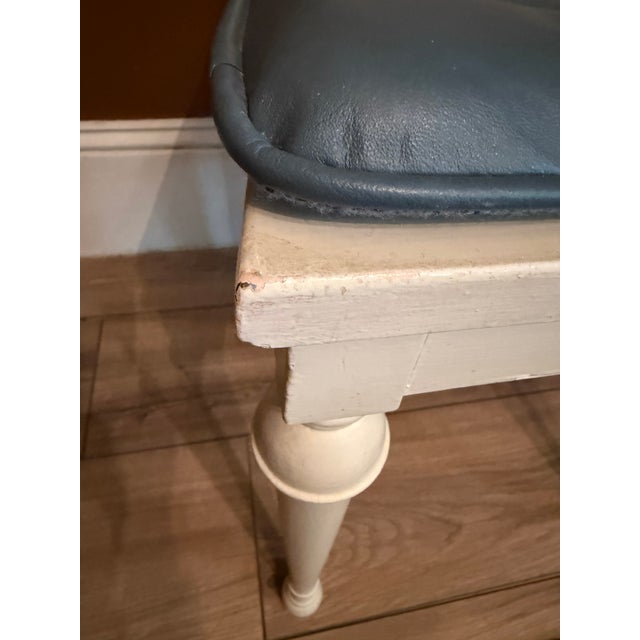 This vintage cane and wood vanity chair is a timeless piece of functional art. Featuring intricate, hand-woven caning and...