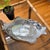 Inspired by the enduring appeal of coastal entertaining, this sculptural cast aluminum serving platter transforms a...