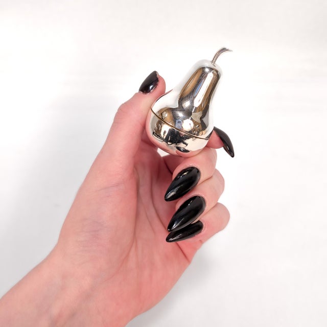 A fine signed vintage silver box. By Tiffany & Co. In sterling silver. In the form of a pear. With a gold wash to the...