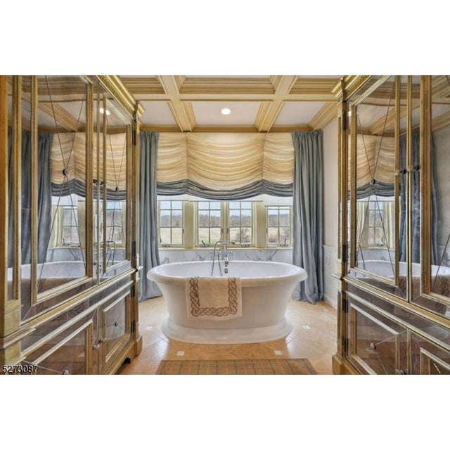 Pair of armoires, the ogee molded cornice over fluted frieze above two long over two short doors with inset mirror plates...