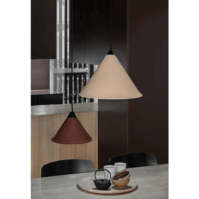 Namibia Leather Cone Medium Lamp by Cuero Design Dimensions: Ø 35 x H 25 cm. Materials: Leather, metal, and cord. Finish:...