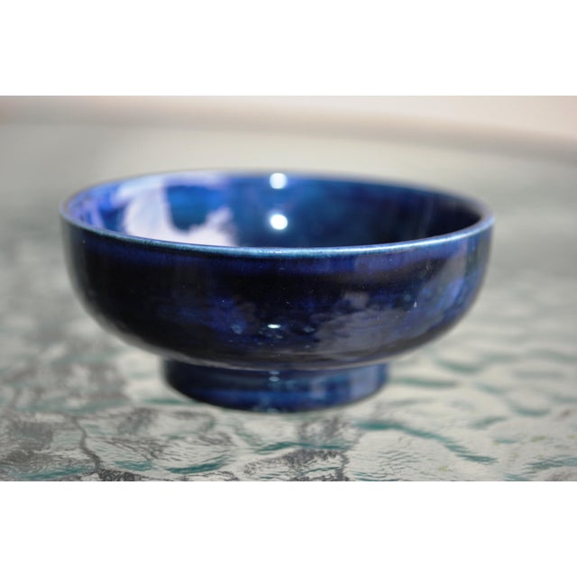 Nice example of Moorcroft pottery in a small form. This is a 3" trinket bowl on a pedestal base. The bowl is rich cobalt...