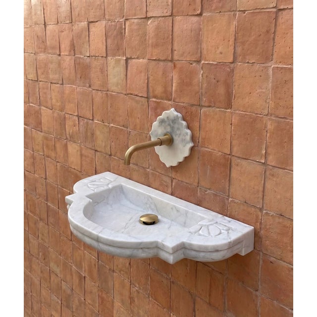 A beautifully sculptural hand-carved Indian marble wall-mount sink, designed with a soft, organic silhouette that brings...