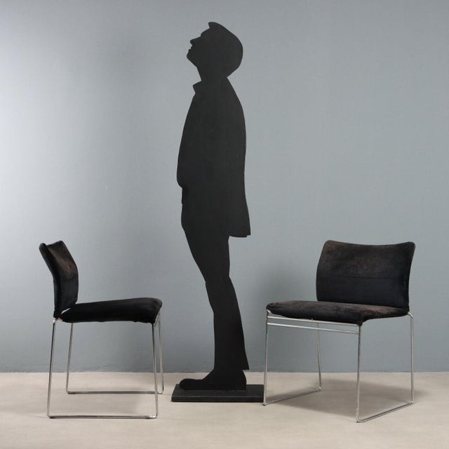 Pair of chairs with chromed metal frame, foam padding and fabric upholstery. This piece is attributed to the mentioned...