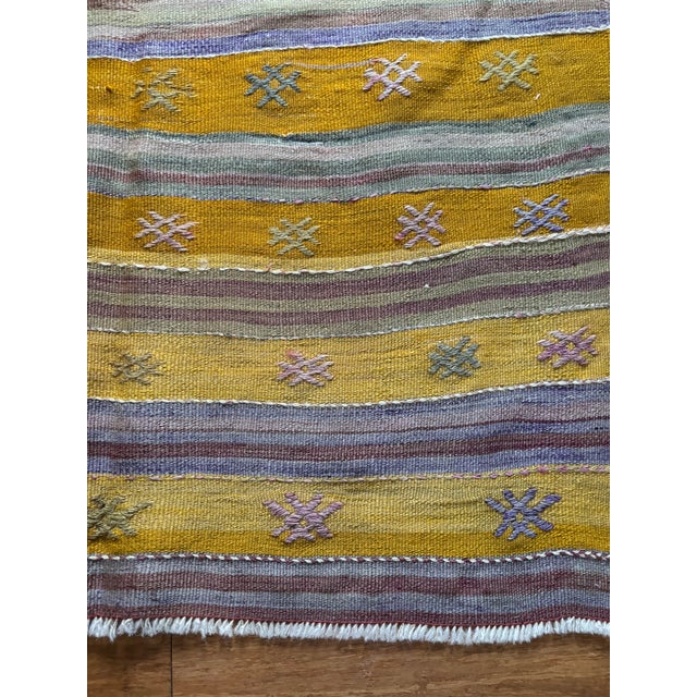 A vibrant and character-rich piece, this vintage Anatolian kilim showcases the expressive beauty of traditional...