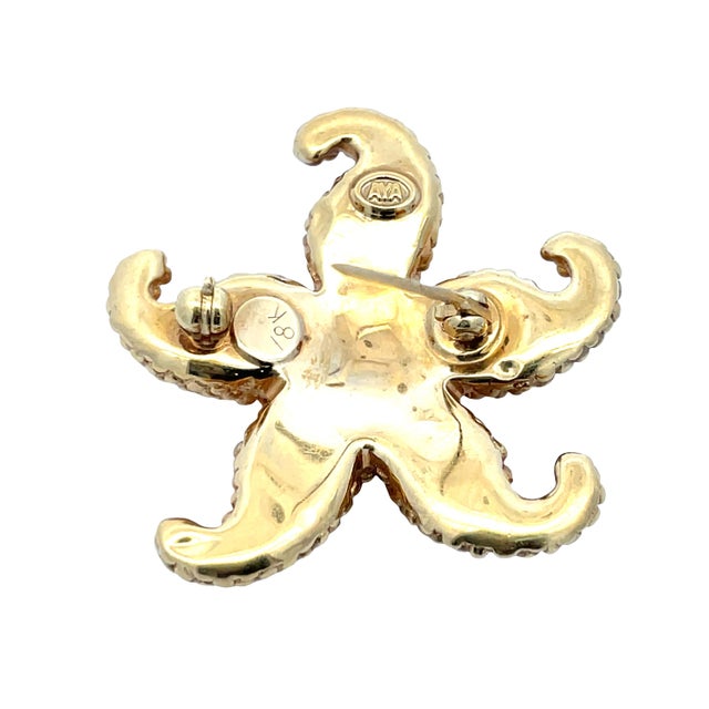 Charming 18K yellow gold starfish pin with rich textured detail and sculptural form. Marked AYA and 18K on the back. This...