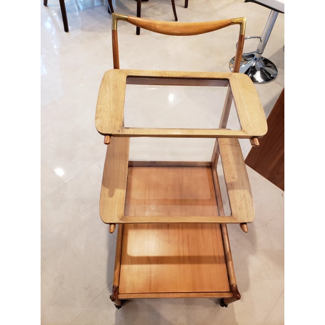 This listing consists of a beautiful 1950s tea or bar cart by Giuseppe Scannell from brazil. The cart is made from caviuna...