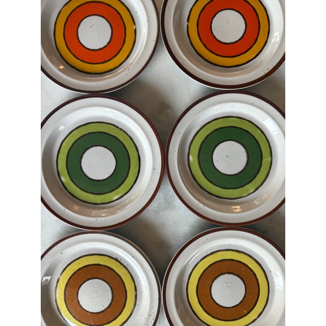 Set of 6 vintage mid century modern small stoneware plates with a bullseye target design and speckled background. Made by...