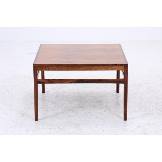 Beautiful vintage rosewood coffee table from the 1960s High-quality workmanship • Danish design • Material: Rosewood...