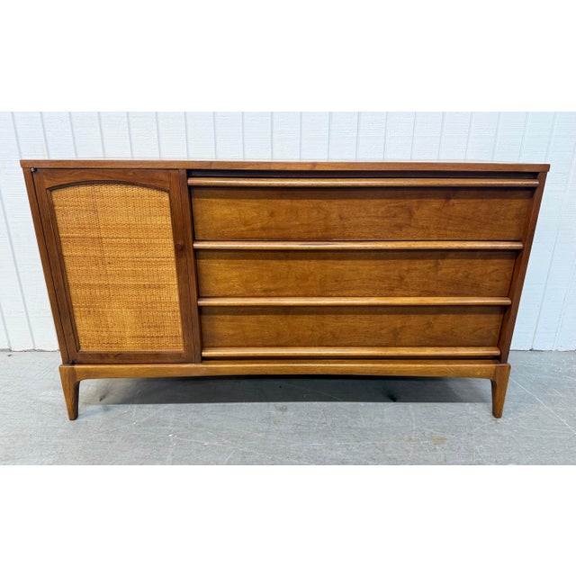 This listing is for a Mid-Century Modern Lane Rhythm Walnut Sideboard. Featuring a straight line design, cane door that...