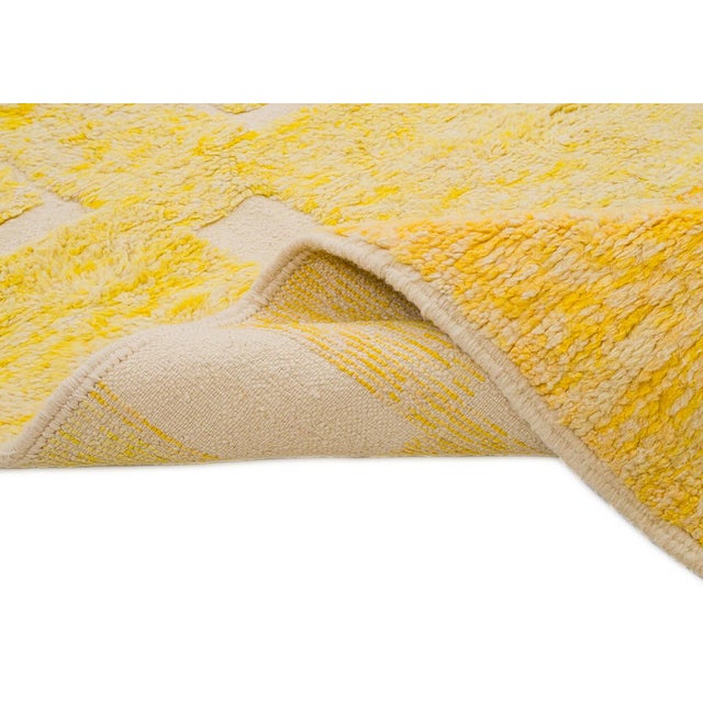A radiant field of sunflower yellow, punctuated by scattered ivory geometric squares that float across the surface like...