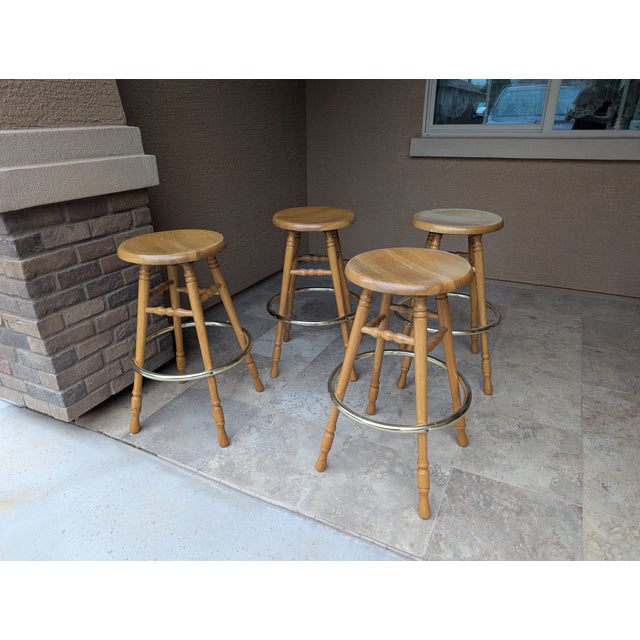 Four Fantastic Oak Bar Stools - solid wood - with brass foot rests. Molded (dipped) seats for comfortable sitting. 30"...