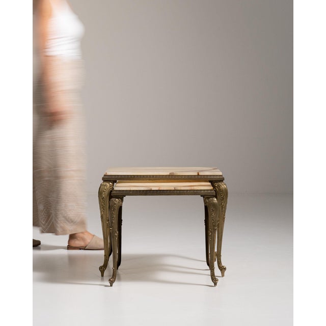 Brass-legged nesting console table in Antique Brass. Finished in antique brass, this brass-legged nesting console table is...