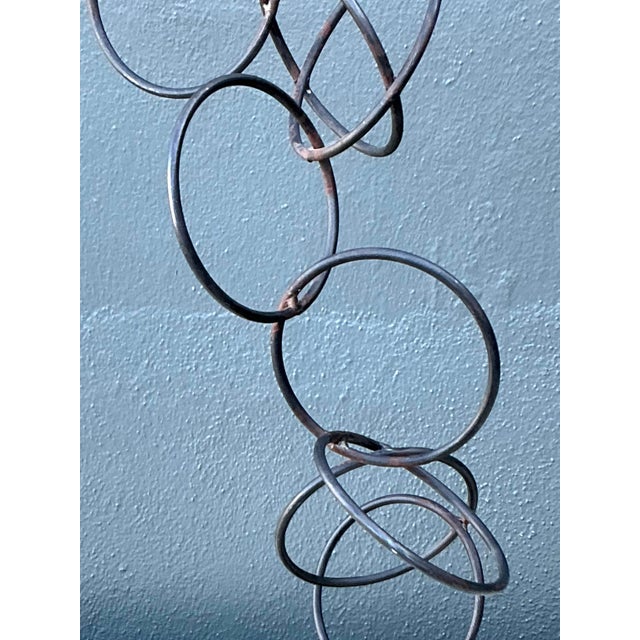 This striking vintage iron sculpture is a masterful example of Brutalist-inspired abstract art. Composed of interlocking,...