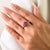 This elegant three-stone ring features one emerald-cut ruby and two emerald-cut blue sapphires totaling 2.03 carats, set...