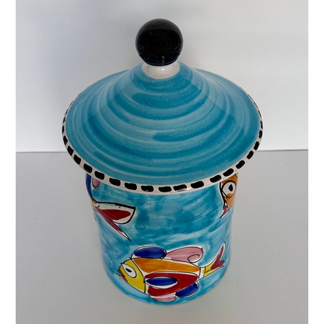 Whimsical Italian hand-painted ceramic cookie jar in the manner of La Musa Ceramiche. The cerulean blue glaze is accented...
