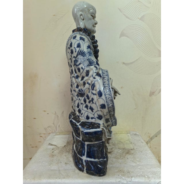 W-22cm,H-34.5cm This hand-carved blue and white porcelain statue depicts The Eighteen Arhats, a traditional Chinese...