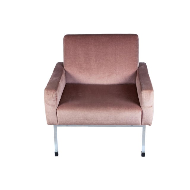 Pair of vintage armchairs produced in Europe during the 1960s and 70s. The design features straight lines and balanced...