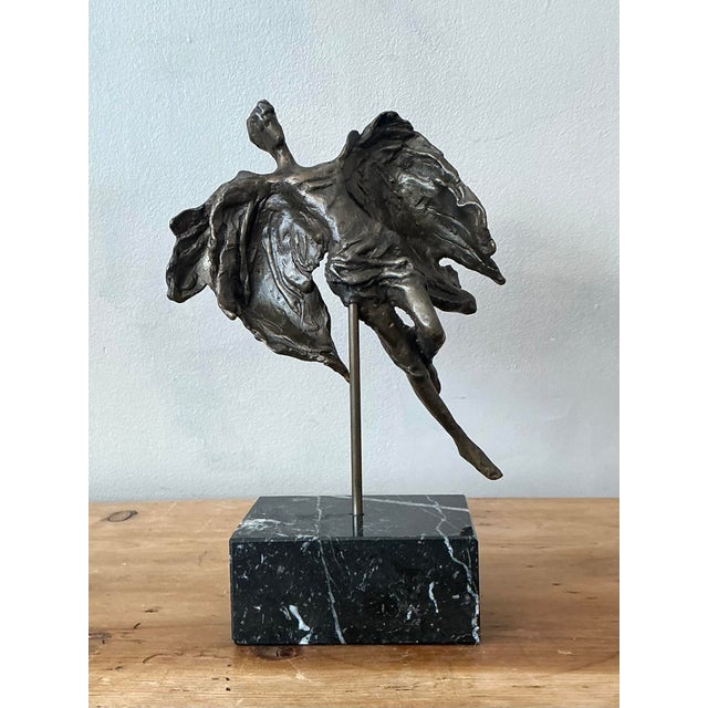 This striking vintage bronze sculpture depicts an angel in a dynamic, mid-air flight, capturing a profound sense of...