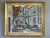 FACADE IN FOCUS Size: 28.7 x 33.9 inches (including frame) Oil on canvas A striking street scene that depicts a...