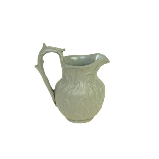Antique relief-molded small jug produced with finely modeled bulrush fronds circling the perimeter. Produced by Ridgway &...