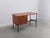 Nice minimalist desk in the style of Pierre Guariche produced in Belgium around 1960. Made of teak combined with a black...