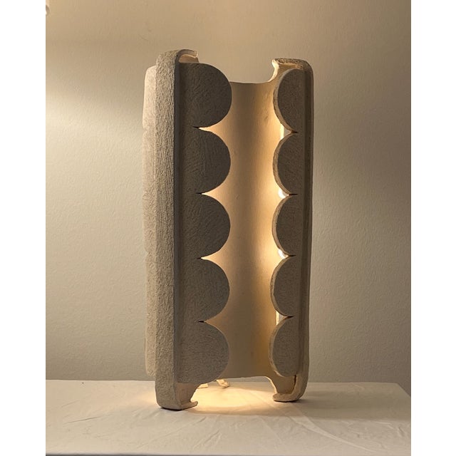 The Stone Flower Table Lamps feature three legged ceramic construction in off white finishes. The ceramic material...