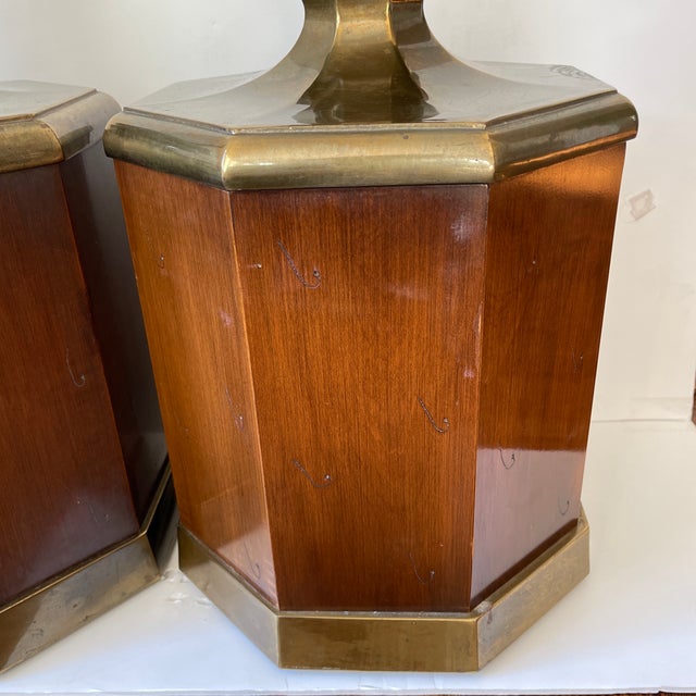 Pair of walnut lamps. Large. Octagonal in shape with brass detail.