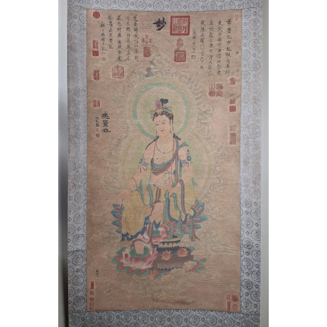 Chinese seated Kuanyin scroll, colored inks on heavy paper, mounted on a shimmering blue and silver, grey and black, silk...