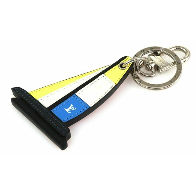 The Louis Vuitton Latitude Sailboat Bag Charm is a stylish keychain designed for women. This handbag charm features the...