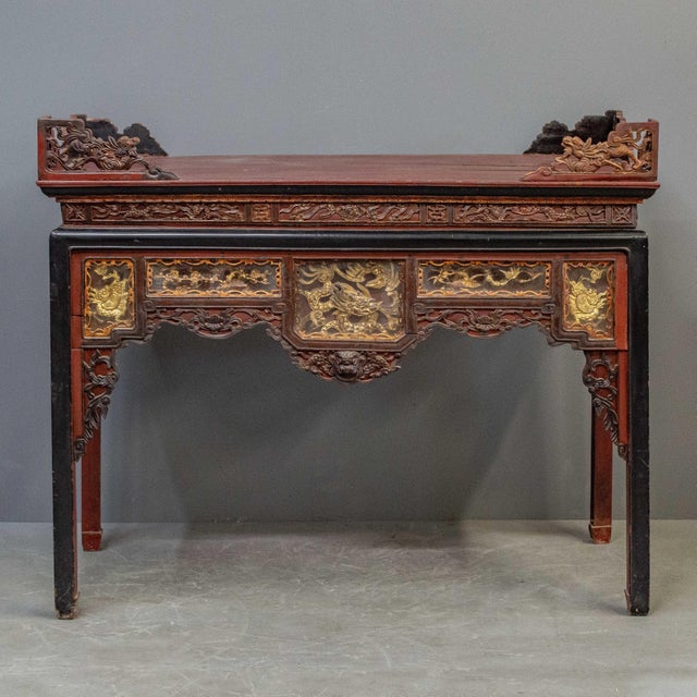 Tall antique red, black and parcel gilt Chinese altar table carved on three sides. A couple of unusual features are the...