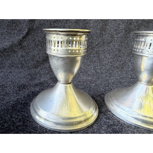 Polished, vintage pair of sterling silver weighted candlesticks. Simple bases with pierced tops. Signed Duchin, Sterling...