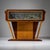 Mid-century Italian design bar in trapezoidal form with an elegantly constructed base and back panel, veneered in two-tone...