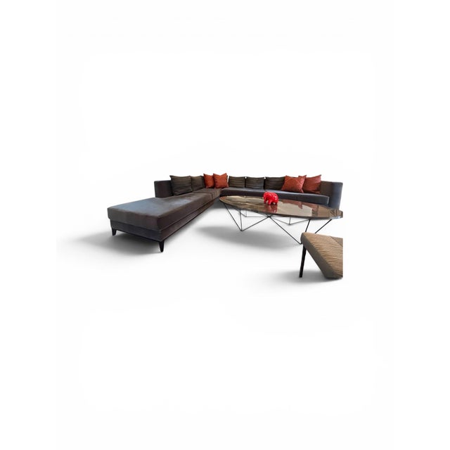 Custom designed charcoal gray sectional sofa featuring sophisticated upholstery in soft, durable fabric ideal for pets....