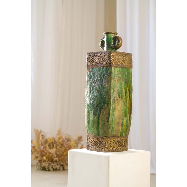 This handcrafted Tamegroute ceramic vase showcases a rich green glaze layered with natural variations, complemented by...