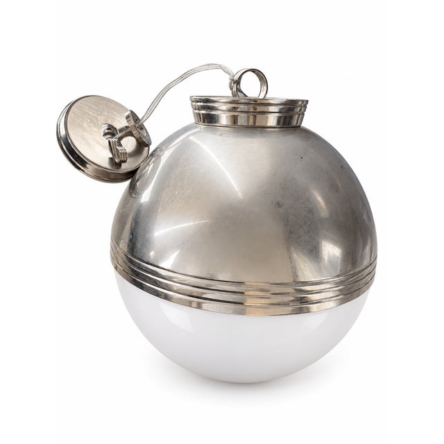A pair of Ralph Lauren globe pendants featuring rounded white shades and polished silver-finished tops. Each pendant is...