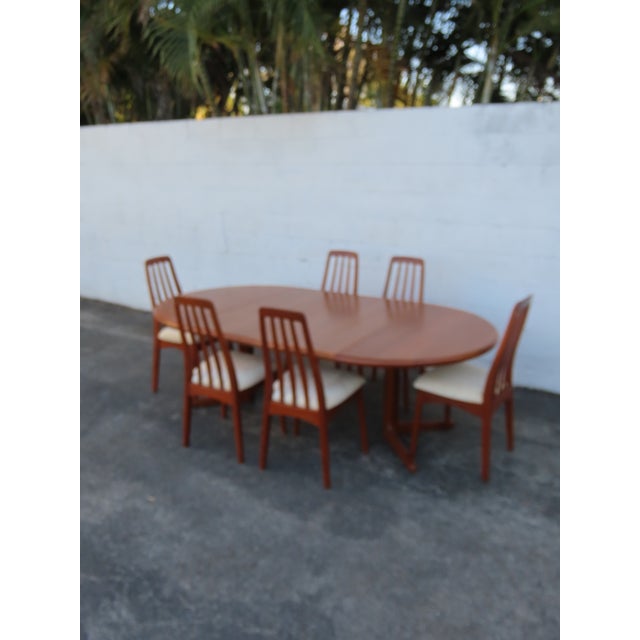 This classic Set of Dining Table and Six Chairs and 2 Leaves is made of wood, teak wood, veneer, and upholstery. The Table...