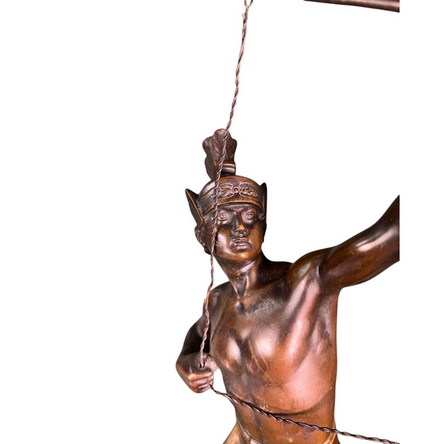 Bronze figure of a Native American archer, signed in the bronze O. Hartel. The figure is depicted standing with a bow,...