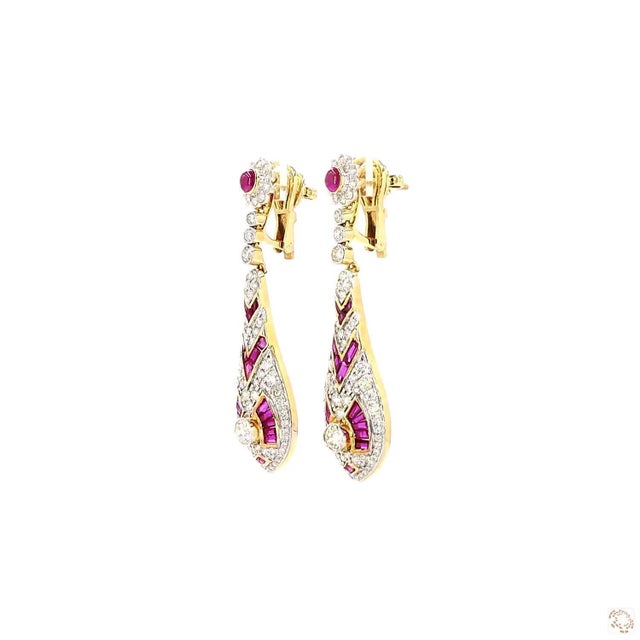 This pair of estate earrings centers on a 4.78-carat diamond in a round brilliant cut for lively, classic sparkle. It is...