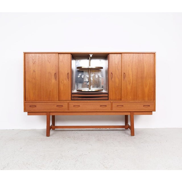 Unique vintage highboard from the 1960s, produced in denmark. this beautiful cabinet is finished with warm teak veneer and...