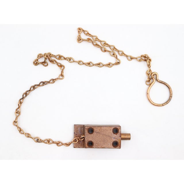 Cabinet latch with a brass finish and operated by a long chain. These are old new stock, never used. There may be signs of...